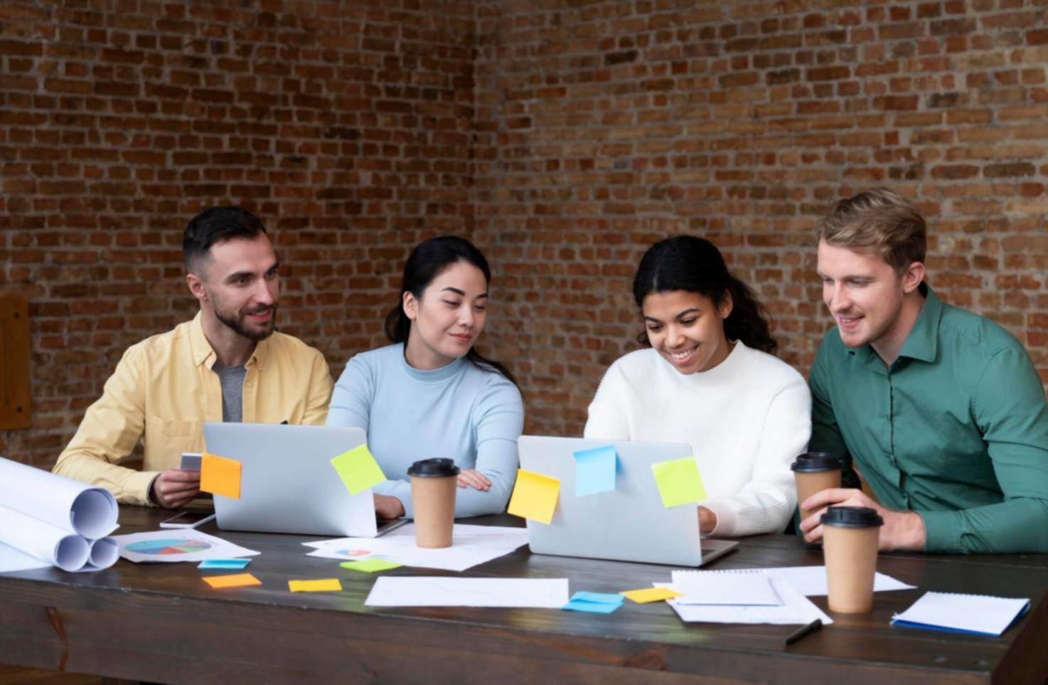 Team member reviewing expense categorization accuracy metrics on multiple screens